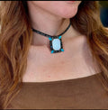 A model wearing the Turquoise Choker necklace to demonstrate the size of the pendant relative to the neckline."