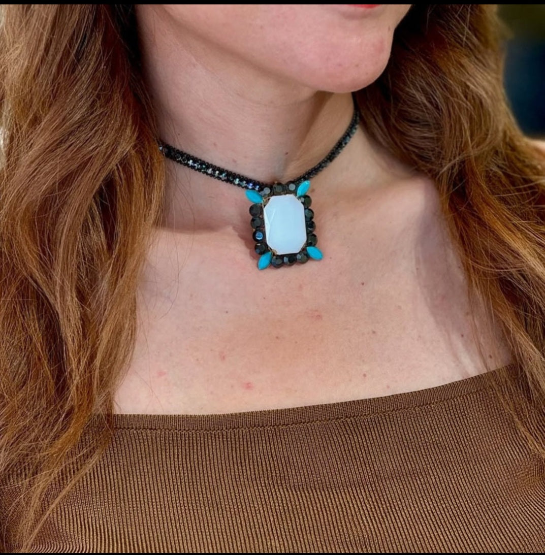A model wearing the Turquoise Choker necklace to demonstrate the size of the pendant relative to the neckline."
