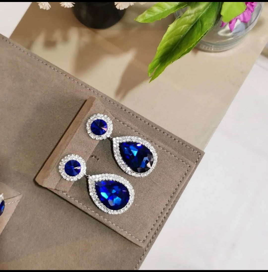 Handcrafted Royal drop earrings featuring deep royal blue teardrop-shaped crystals surrounded by a halo of clear Swarovski stones.